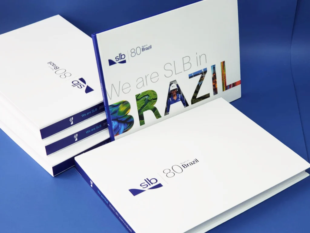 Livro comemorando os 80 anos da SLB no Brasil, em caixa personalizada, produzidos e impressos pela Copy House no Rio de Janeiro.